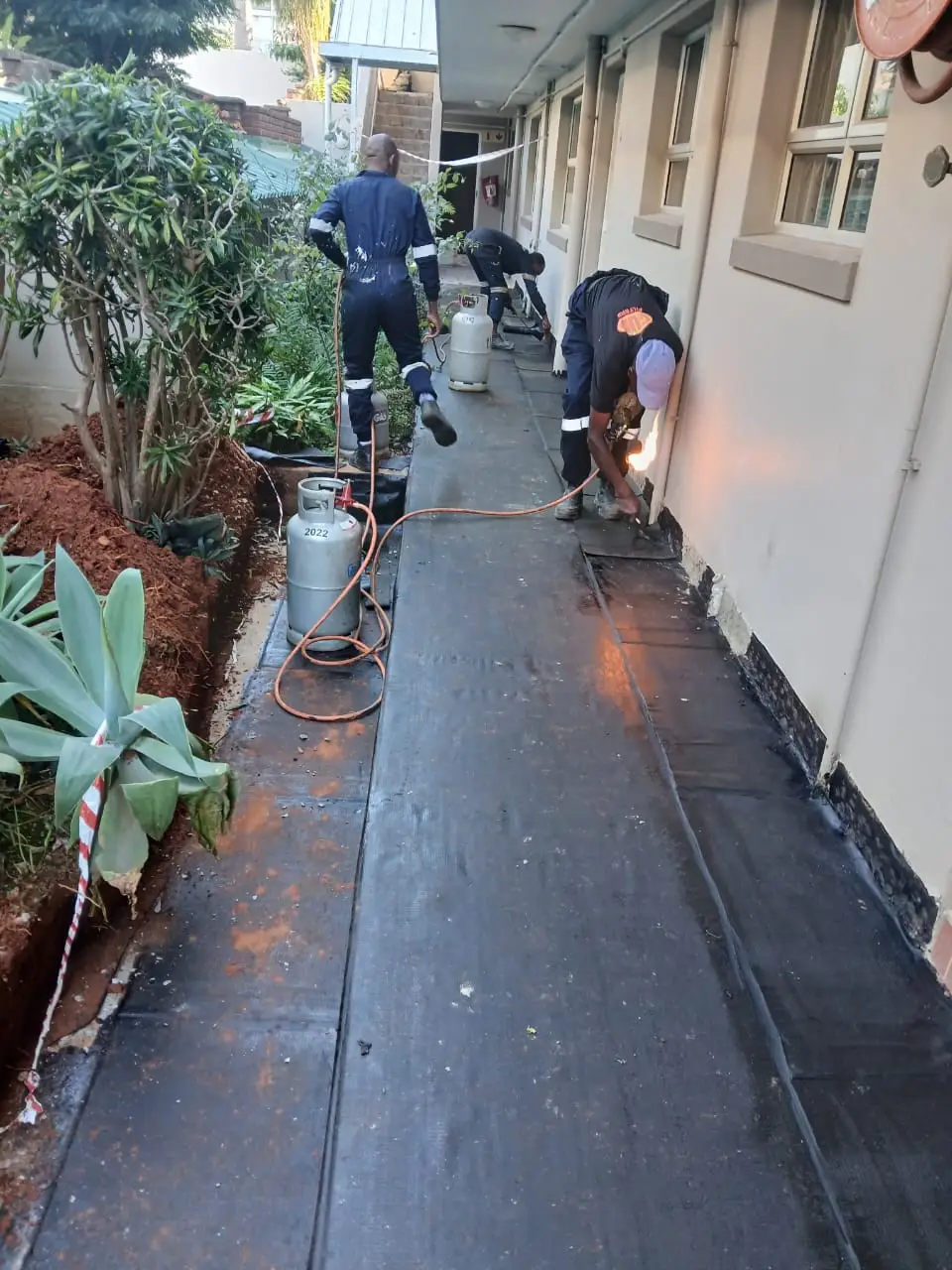 Torch-on waterproofing on coastal building in Durban